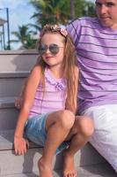 Happy father and his cute little daughter at beach photo