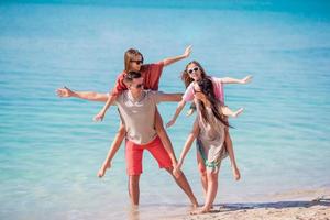 Happy beautiful family on a tropical beach vacation photo