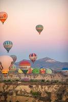 GOREME, TURKEY - SEPTEMBER 18. 2021, Bright hot air balloons in sky of Cappadocia, Turkey photo