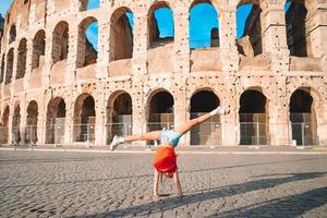 Little girl in front of colosseum in rome, italy photo