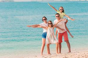 Photo of happy family having fun on the beach. Summer Lifestyle