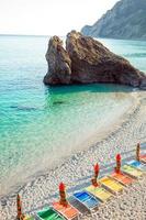 Sunbeds and umbrellas at beautiful european seashore in Monterosso in Italy, Cinque Terre, Liguria photo