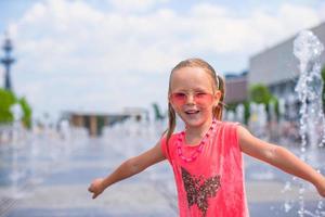 Adorable girl have fun at hot sunny day photo