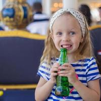 Portrait of little adorable charming girl with bottle water photo