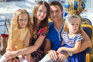 Portrait charming beautiful family of four in restaraunt photo