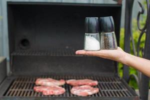 Grilled steak cooking on an open barbecue photo