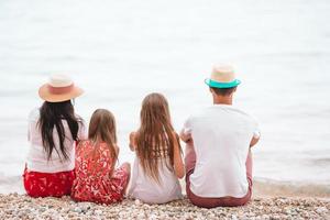 Happy beautiful family with kids on the beach photo