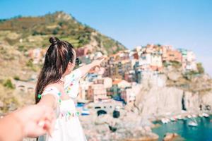 turista mirando la vista panorámica de manarola, cinque terre, liguria, italia foto