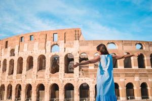 Young female tourist looking at the Colosseum outside in Rome, Italy. photo