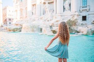 Adorable little girl background Trevi Fountain, Rome, Italy. photo