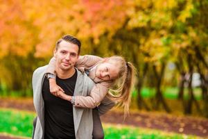 Happy family having fun on autumn day photo