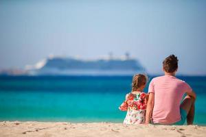 Happy dad and little girl enjoy summer vacation with view on big lainer photo