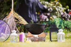 View of Halloween Pumpkins, witch's hat and rake outdoor photo