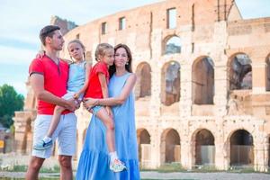 Happy family in Rome over Colosseo background. Italian european vacation together photo