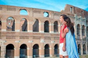 Happy family in Europe. Romantic couple in Rome over Coliseum background. Italian european vacation photo
