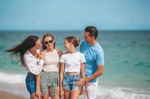 Portrait of happy family on the beach during summer vacation photo