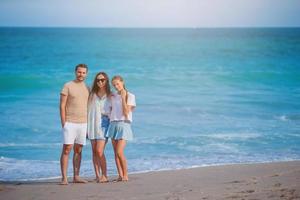 Happy family on the beach during summer vacation photo