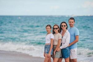 Happy family on the beach during summer vacation photo