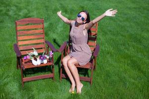 young beautiful woman resting and has fun in the yard photo