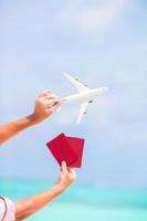 Closeup of passports and white airplane background the sea photo