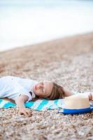 Cute little girl at beach during summer vacation photo