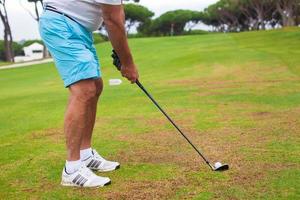 Close-up of a man playing golf photo