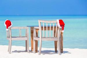 Christmas tropical concept, beach cafe with red Santa Hats photo