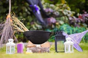 Halloween accessories. Pot, hat, broom, candle, garlic and flashlights photo