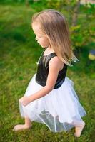 Adorable little girl happy outdoor at summer time photo