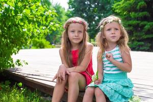 Happy adorable little girls enjoying warm summer day photo