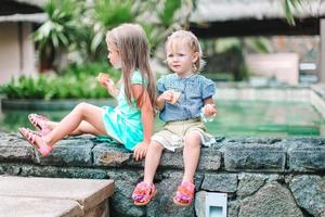 Adorable little girls on summer exotic vacation photo