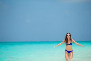 mujer de moda joven en vestido verde en la playa foto