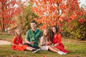 Portrait of happy family of four in autumn photo