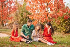 Portrait of happy family of four in autumn photo