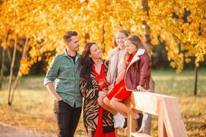 Portrait of happy family of four in autumn day photo