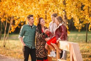 Portrait of happy family of four in autumn photo