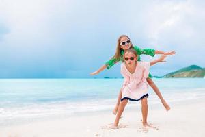 Kids have a lot of fun at tropical beach playing together photo