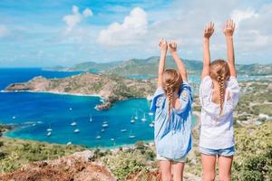 Adorable little kids enjoying the view of picturesque English Harbour at Antigua in caribbean sea photo