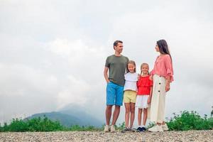 Beautiful happy family in mountains in the background of fog photo