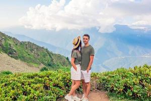 Beautiful happy family in mountains in the background of fog photo