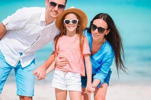 Beautiful tropical beach landscape with family enjoying summer vacation photo