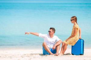 Little girl and happy dad having fun during beach vacation photo