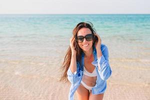 Woman laying on the beach enjoying summer holidays looking at the sea photo