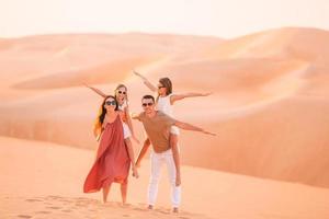 People among dunes in desert in United Arab Emirates photo