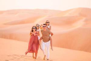 People among dunes in desert in United Arab Emirates photo