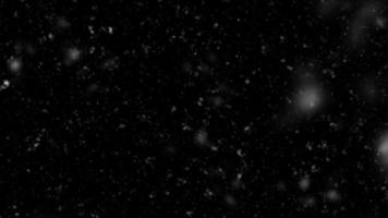 Snowfall bokeh on black background. Many snowflakes in flying in the air. Winte night snowfall and blizzard of snow at. Blur bokeh light effect creative background. photo