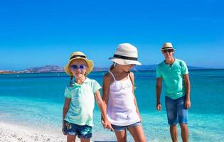 Father and two kids during their tropical vacation photo