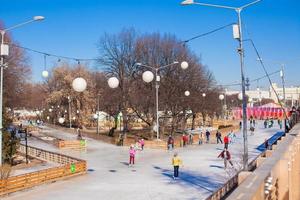 General view of people skating on ice rink photo