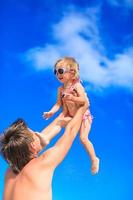 Happy father and adorable little daughter at tropical beach photo