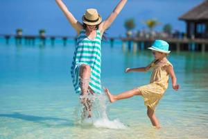 Mother and daughter enjoying time at tropical beach photo